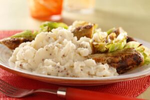 This main course dish combines healthier chicken sausage with cabbage and fluffy mashed potatoes that get a flavor boost from whole grain mustard.
