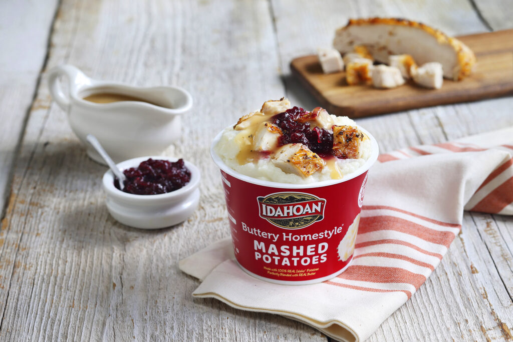 Idahoan Buttery Homestyle Mashed Potatoes in a cup with leftover turkey, gravy and cranberry sauce.